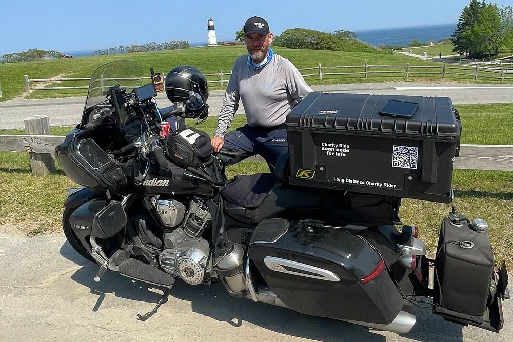 Patrick Cornell stands alongside his heavily modified Indian Pursuit.