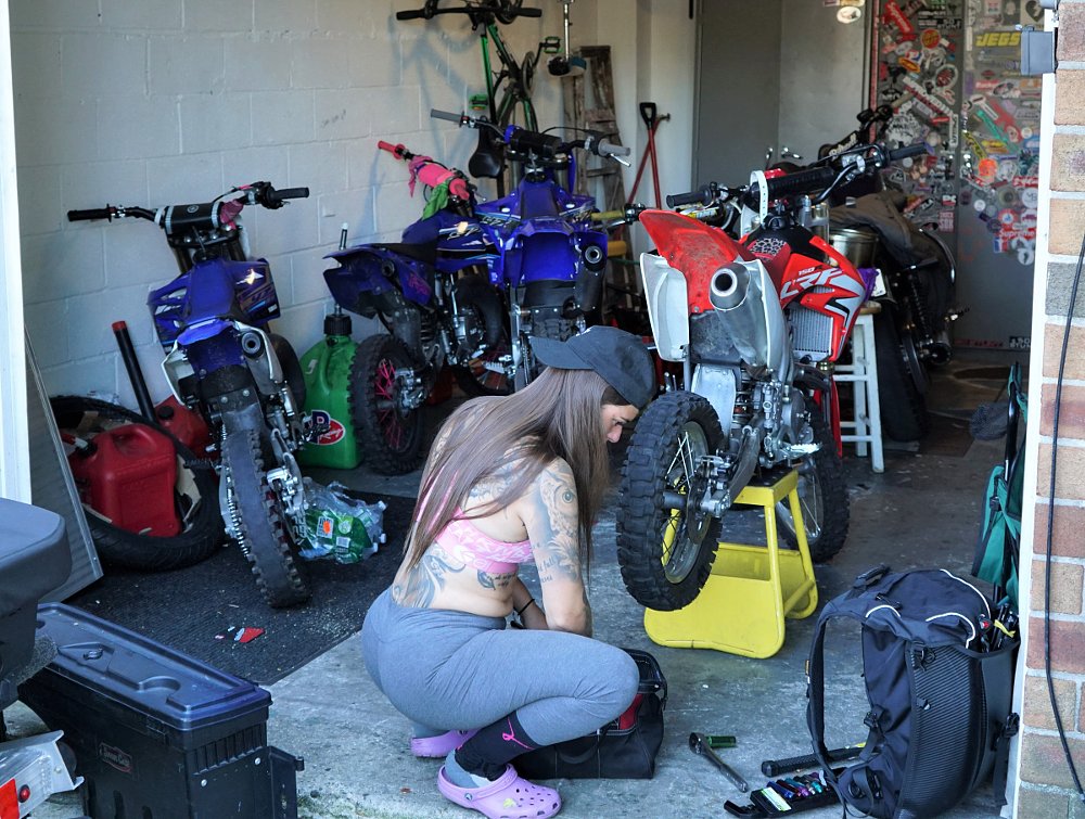 Marissa Alexis working on her motorcycle