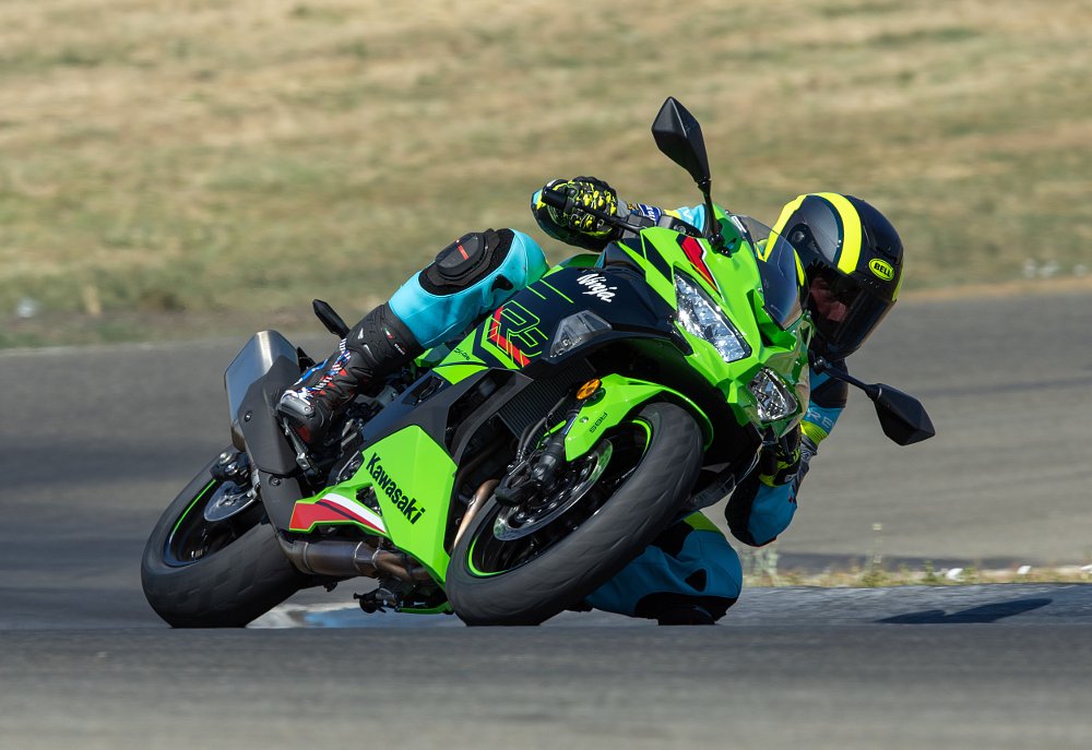 2023 Kawasaki ZX-4RR leaning left through a turn on a race track.