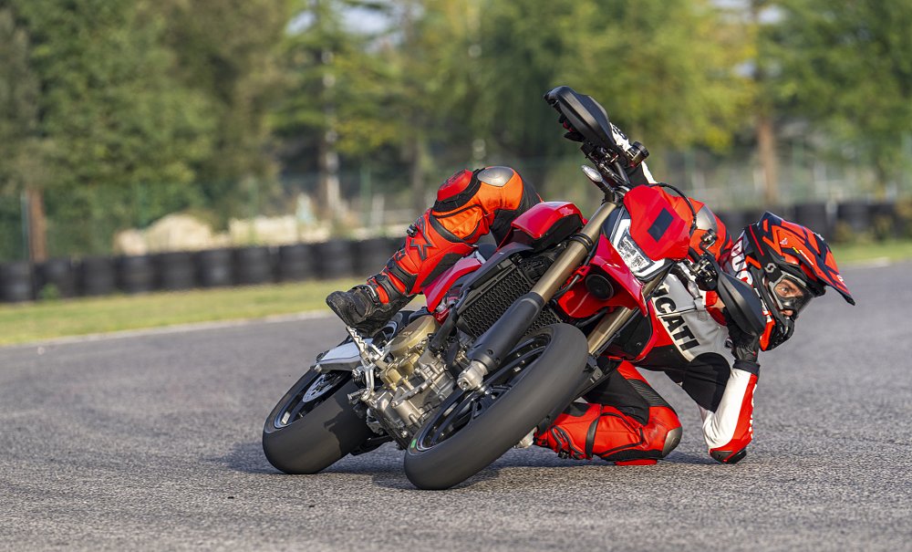 rider at extreme lean angle on a Ducati Hypermotard 698 on the race track