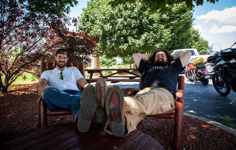 Spurgeon and Lemmy relaxing in the shade with their feet propped up