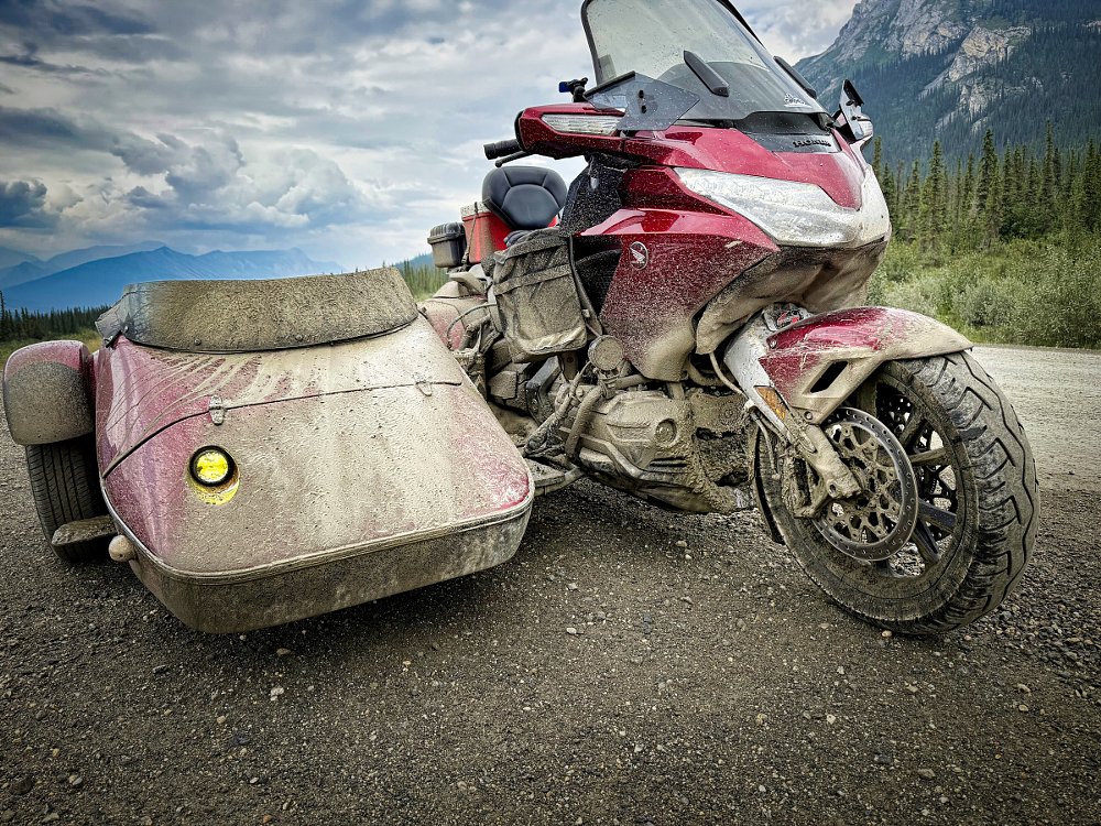 Daub's Gold Wing and sidecar covered with dirt and mud from the road